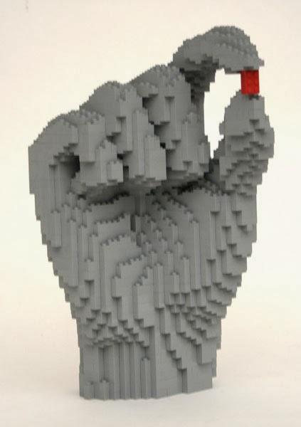 Lego model of a massive grey hand holding a re lego piece. 