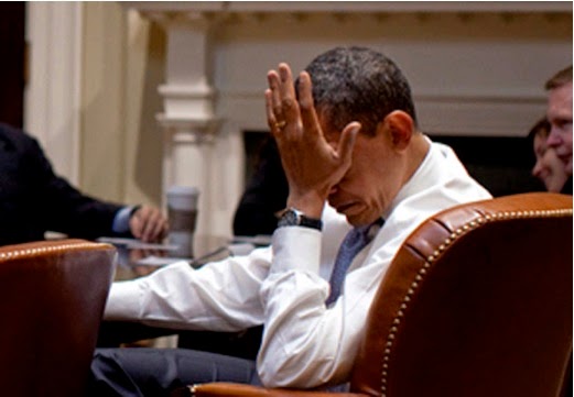 Barrack Obama holding his palm to his face. 