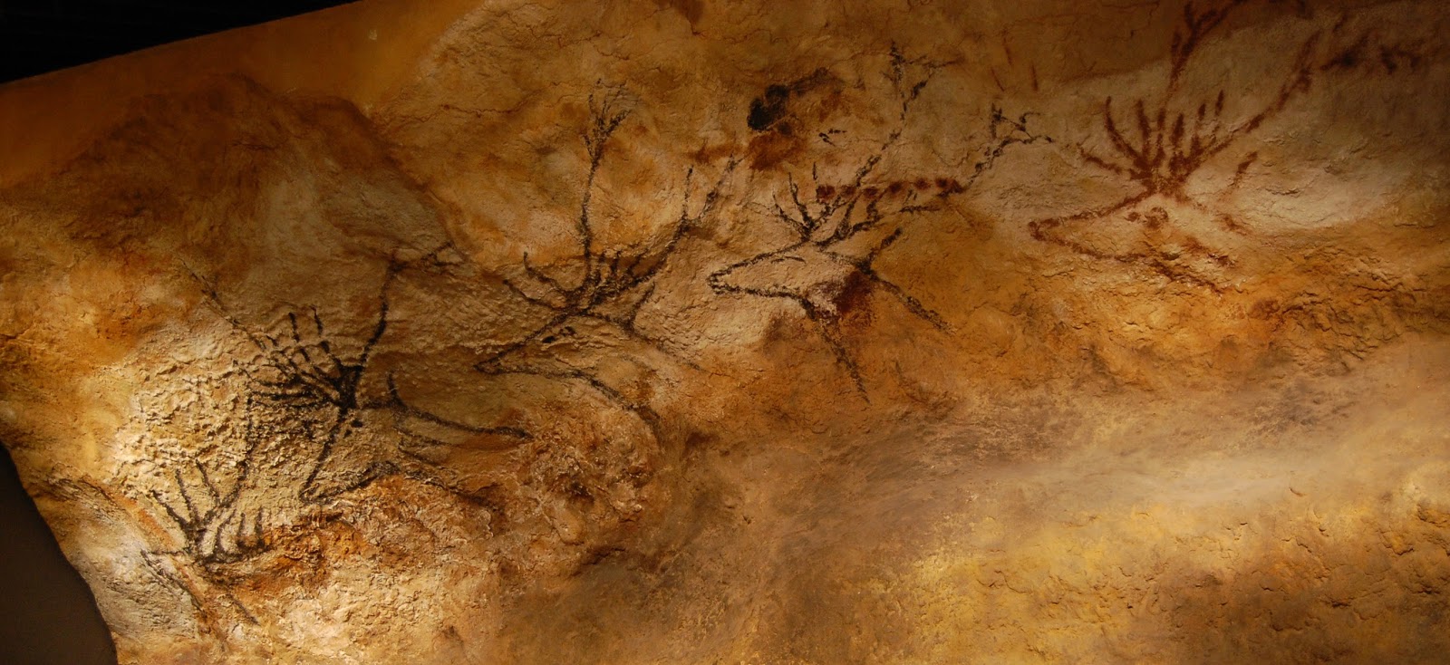 Cave painting of a family of animals with antlers. 
